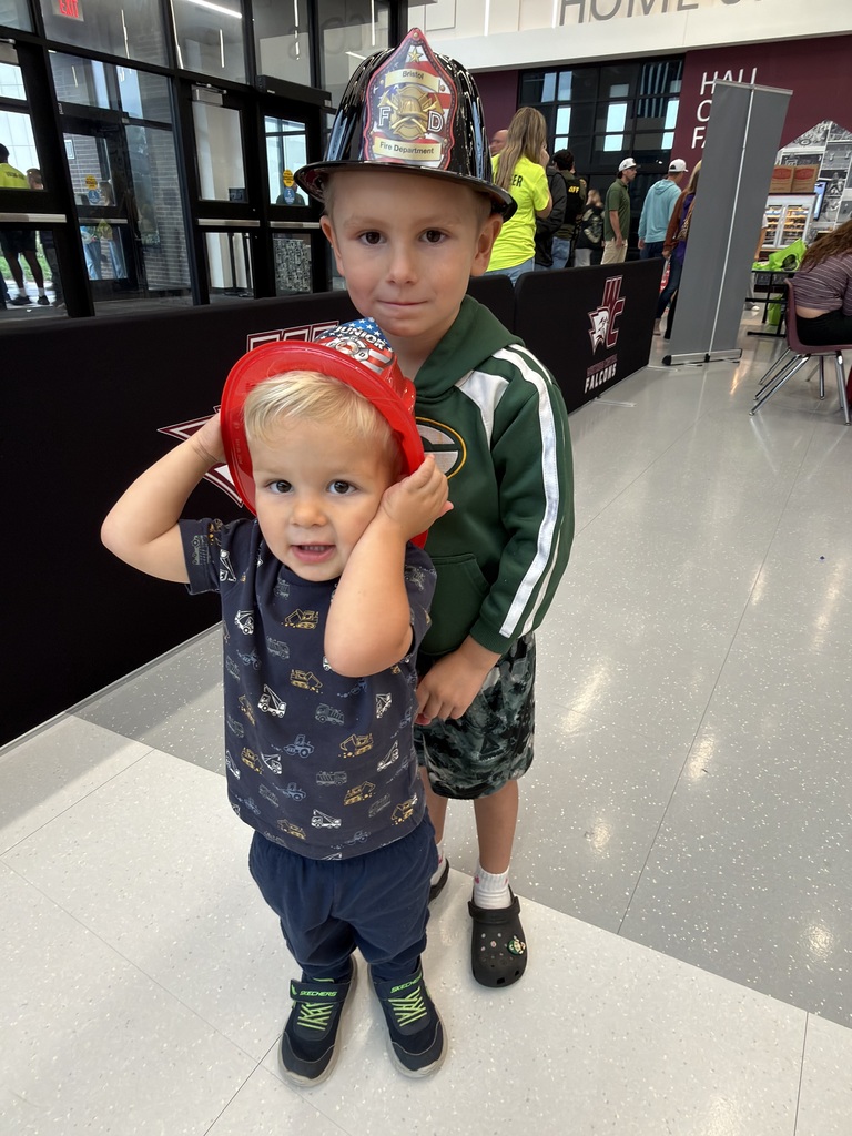 Two boys in fire hats