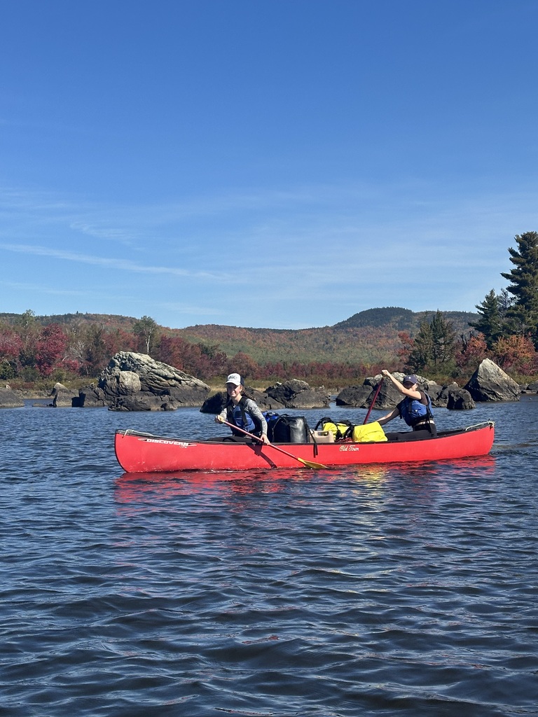 8th grade students paddling a canoe full of gear