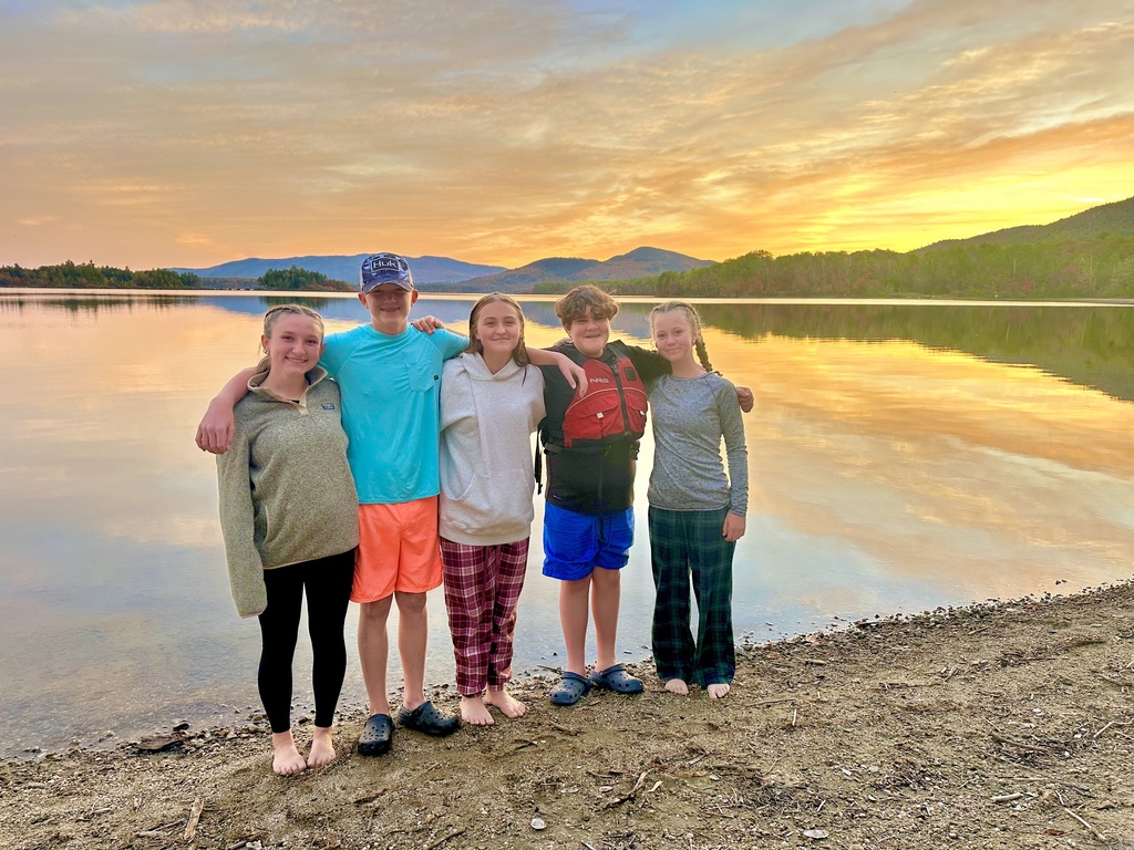 8th grade students on the shore of attean pond