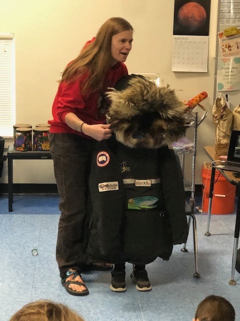 musher dressing student in musher gear