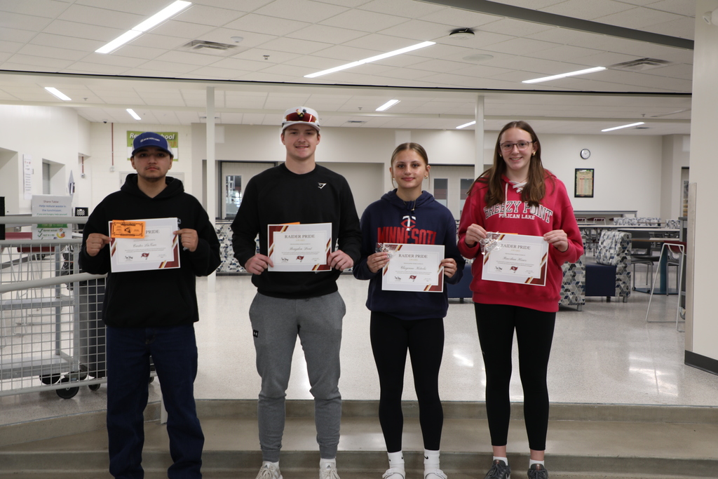 4 Students holding awards for their contributions to the school