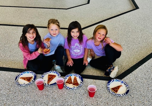 students eating at a pizza party