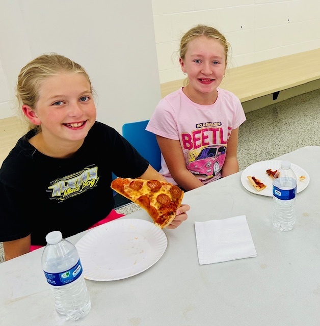 students eating at a pizza party