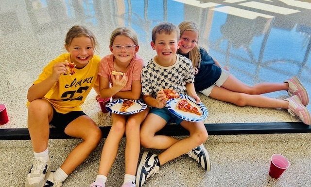students eating at a pizza party