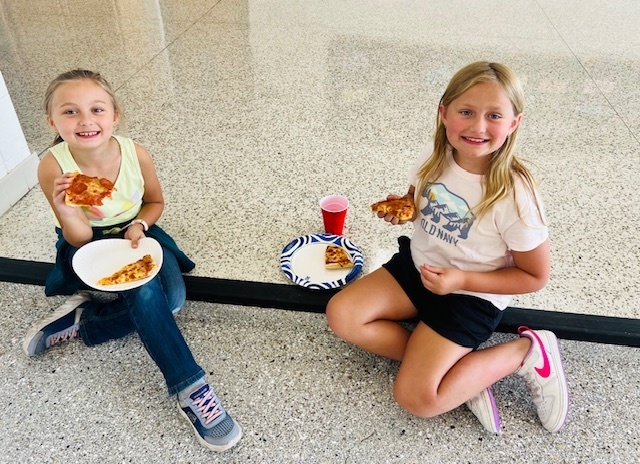 students eating at a pizza party