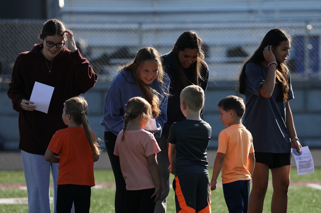 Senior students meeting kindergarteners to exchange school spirit.