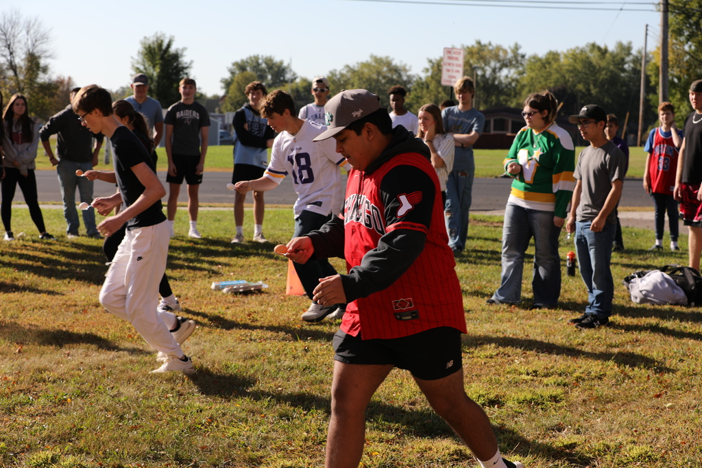 High School Students participating in an egg race