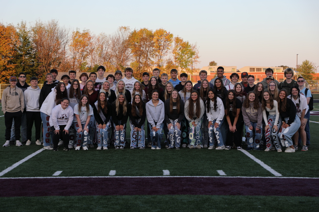 The senior class posing for a picture on the football field during sunrise breakfast