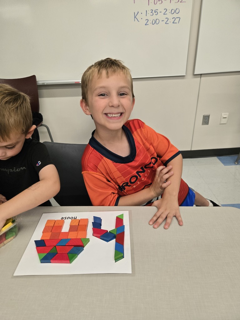 students using blocks to build letters and shapes