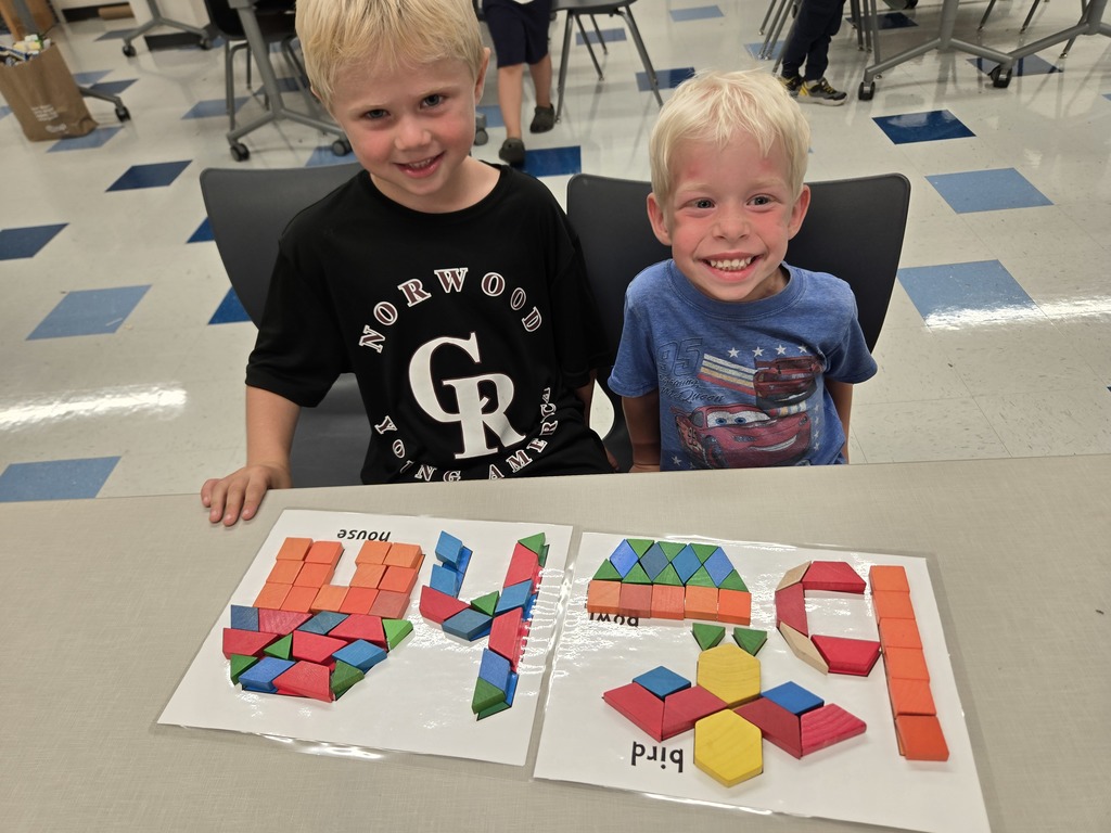 students using blocks to build letters and shapes