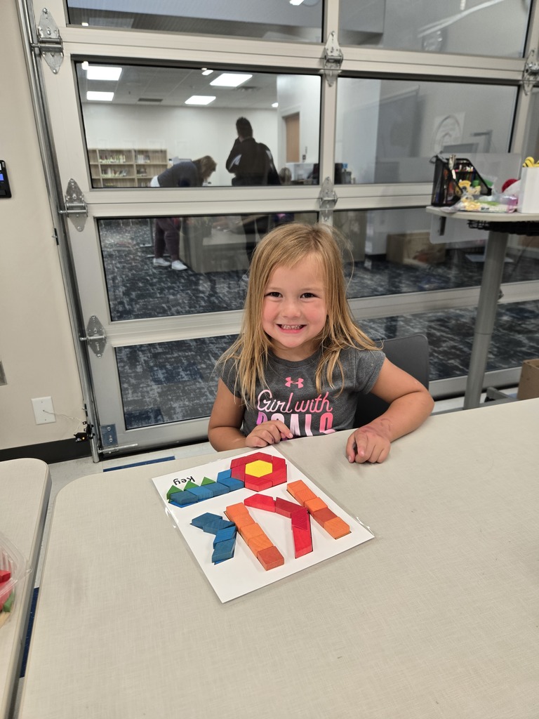 students using blocks to build letters and shapes