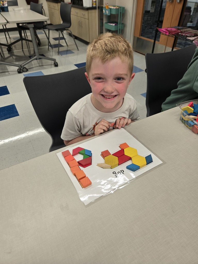 students using blocks to build letters and shapes