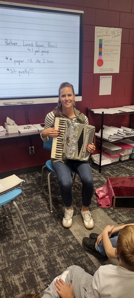 class watching teacher play accordion