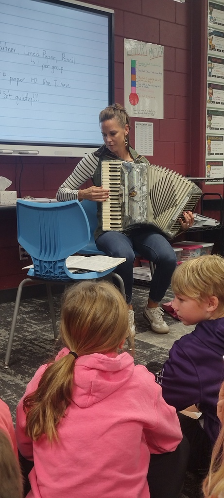 class watching teacher play accordion