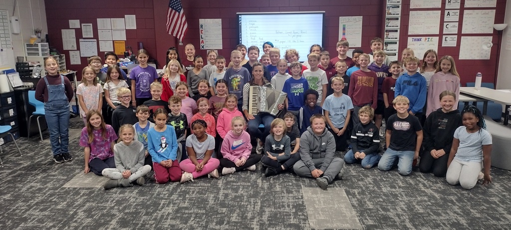 class watching teacher play accordion