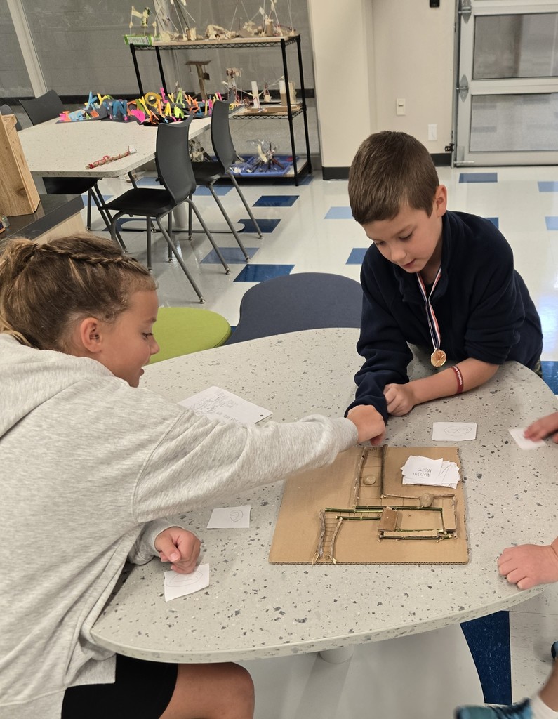 students creating games out of nature materials