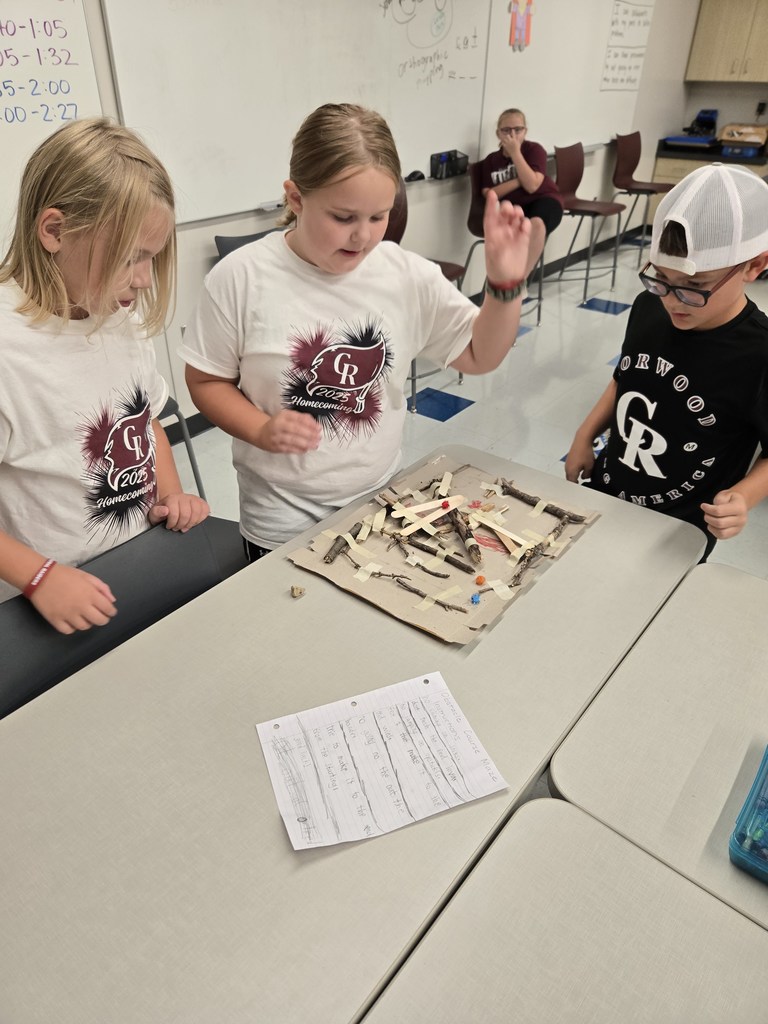 students creating games out of nature materials
