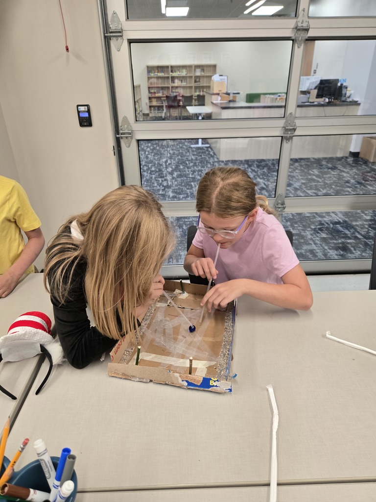 students creating games out of nature materials