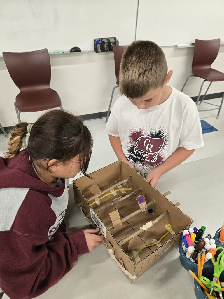 students creating games out of nature materials