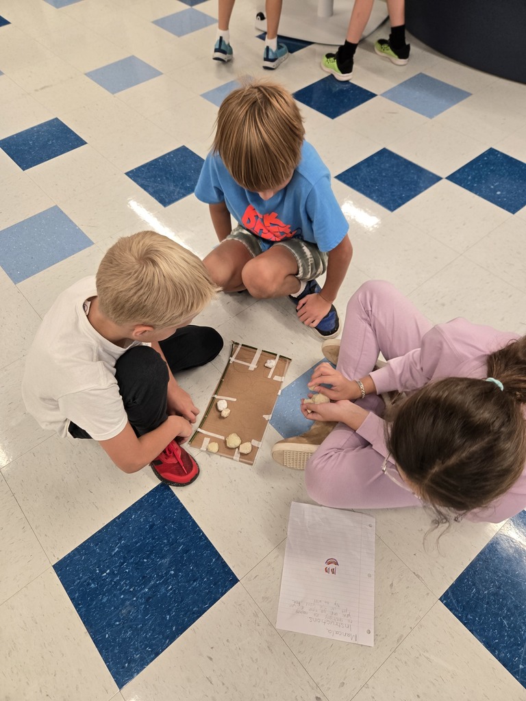 students creating games out of nature materials
