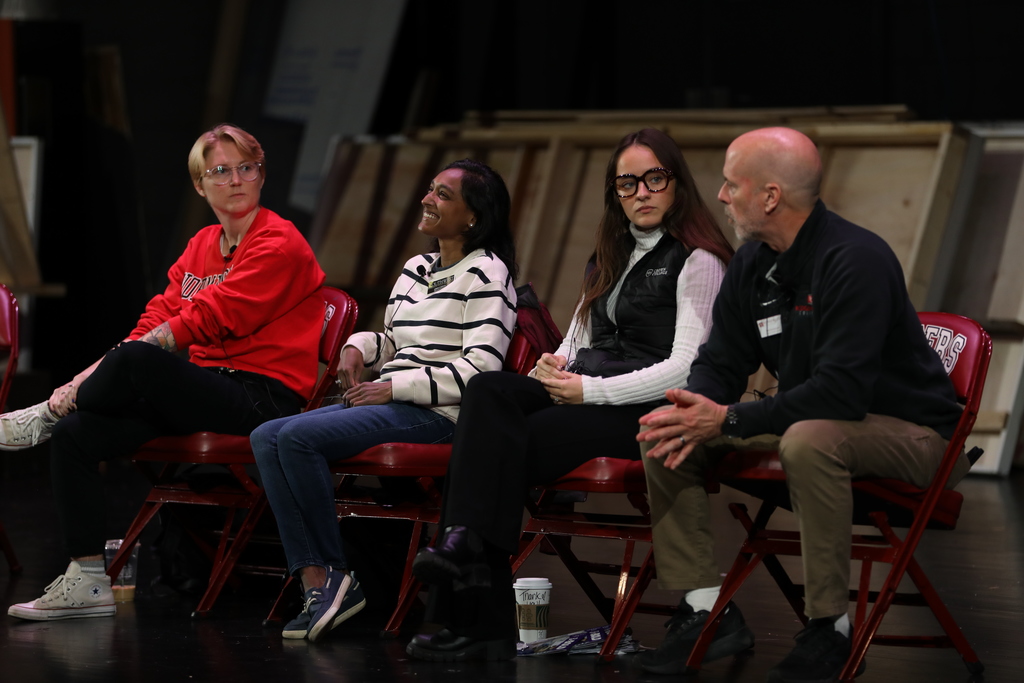 Panel of college reps talk to high school students. 