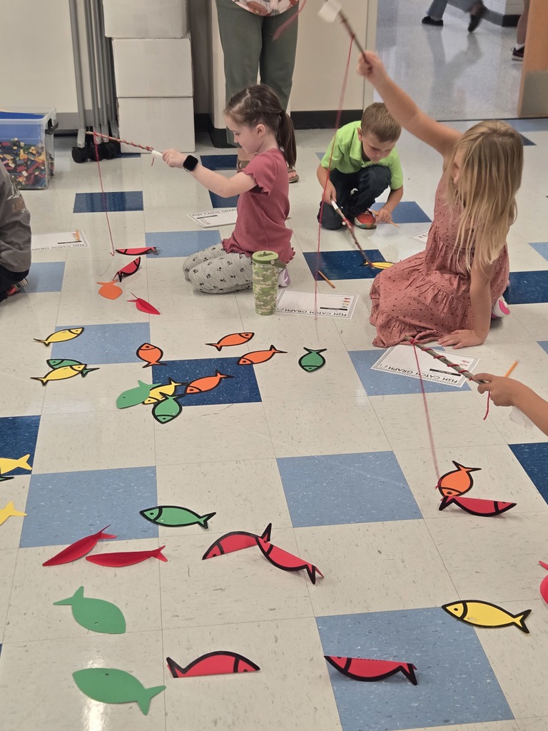 young students using sting and sticks to fish for paper fish