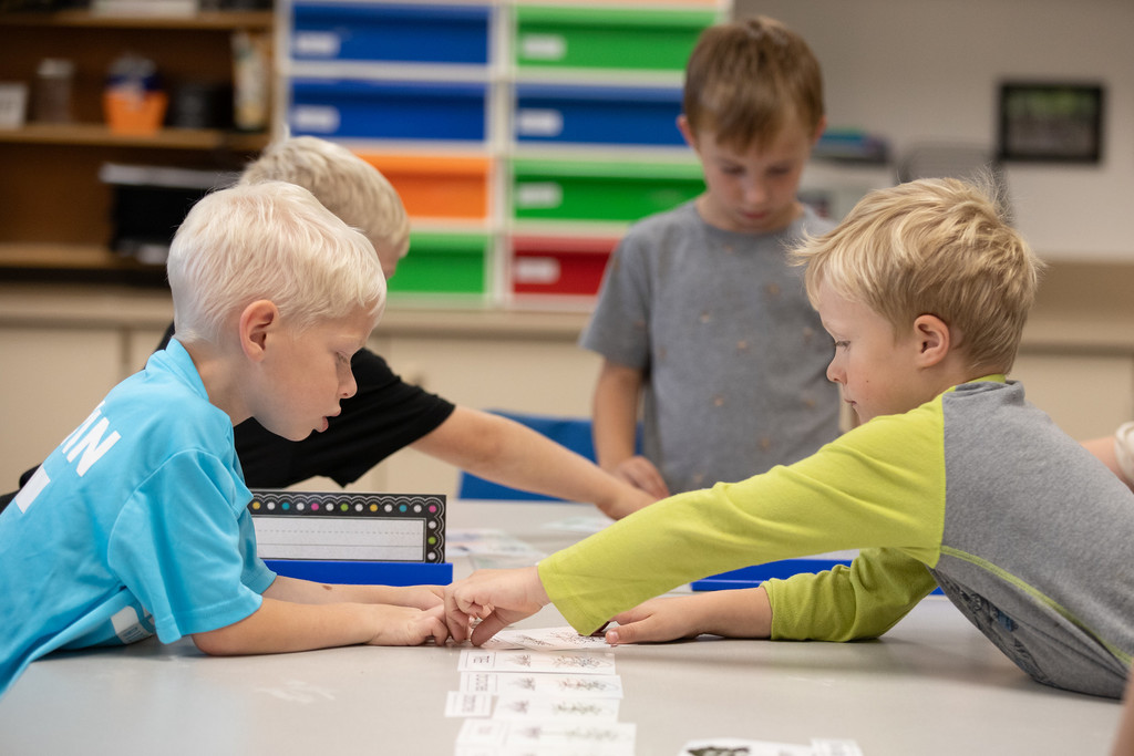 young students working together at table
