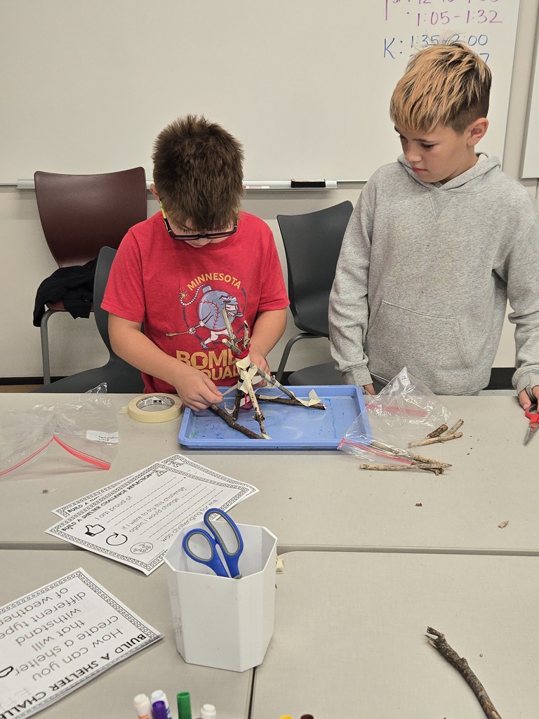 fourth grade students building shelters