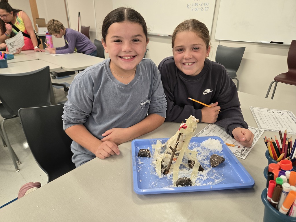 fourth grade students building shelters