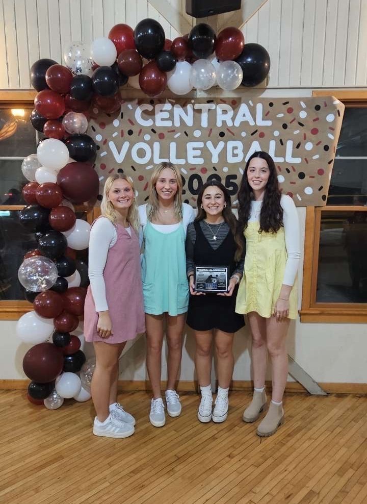 4 volleyball players posing with an award for being name all-conference and honorable mentions for all-conference