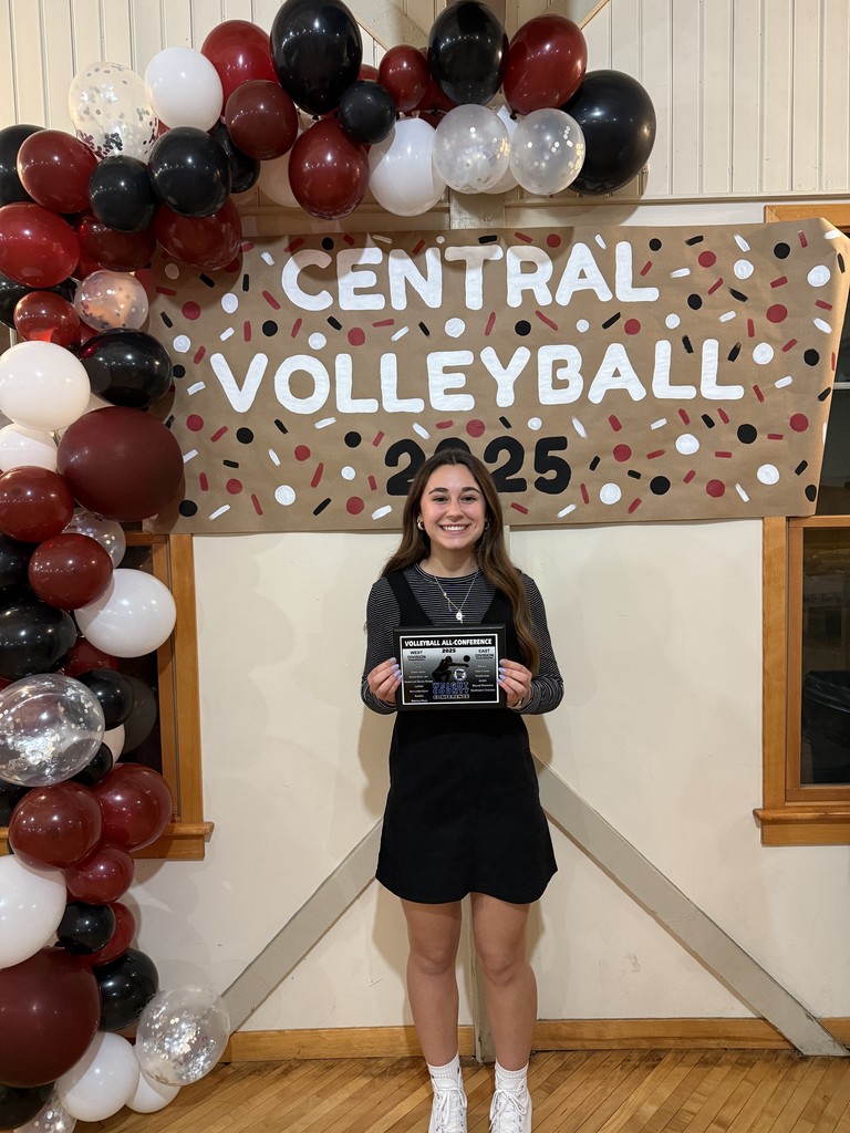 A volleyball player holding an award for making All-Conference