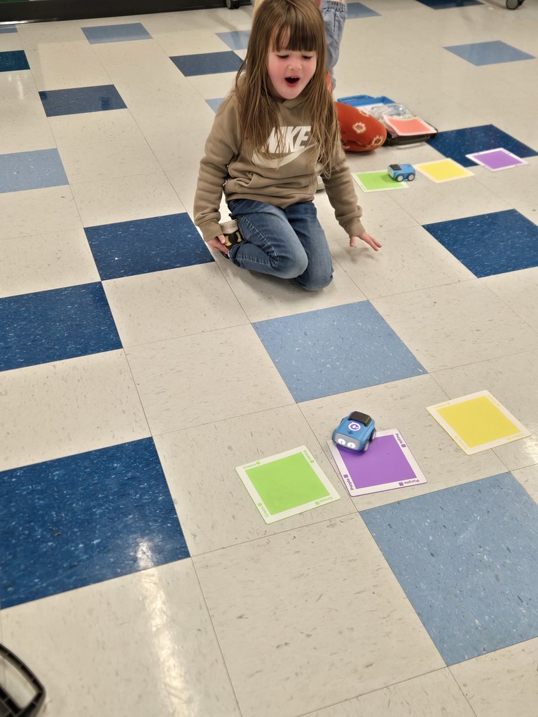 kindergarten and first grade students working with indi race car in stem