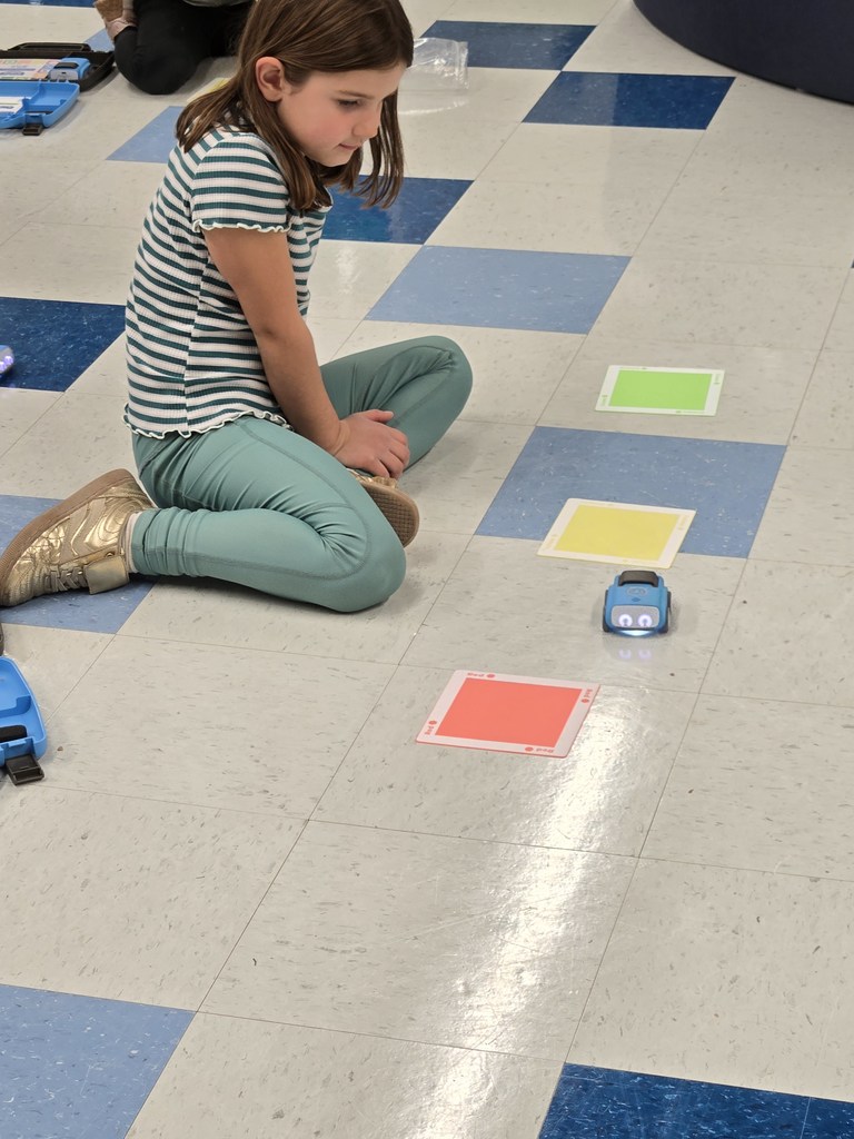 kindergarten and first grade students working with indi race car in stem