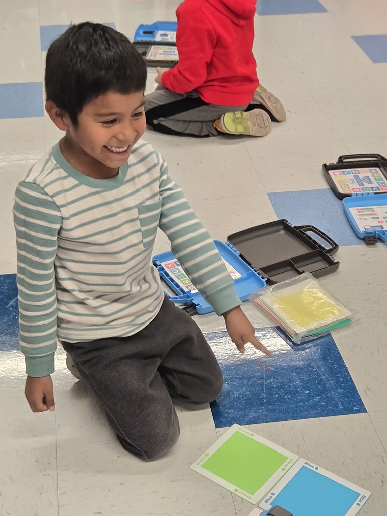 kindergarten and first grade students working with indi race car in stem