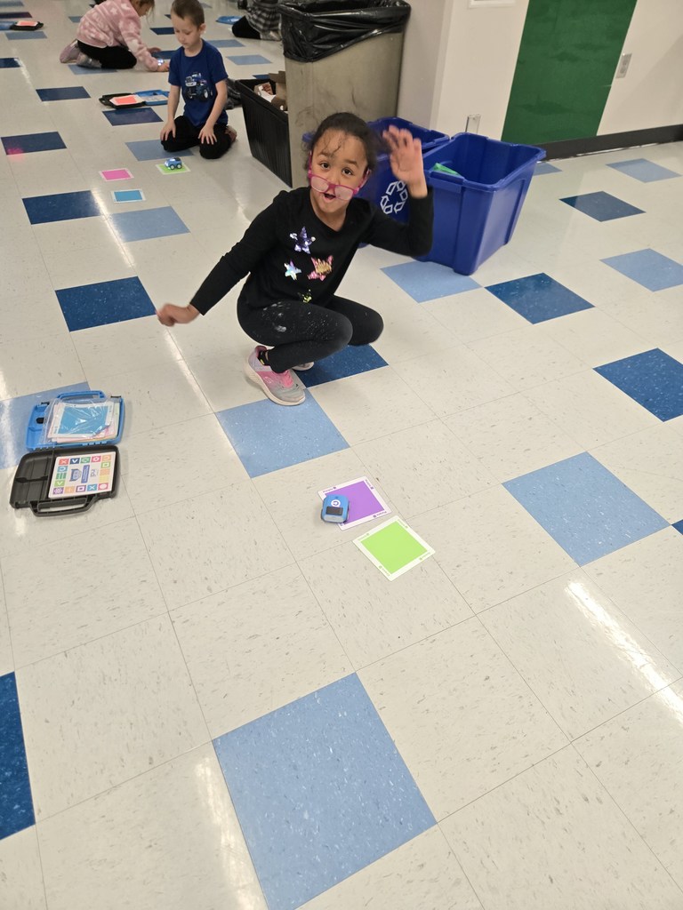 kindergarten and first grade students working with indi race car in stem