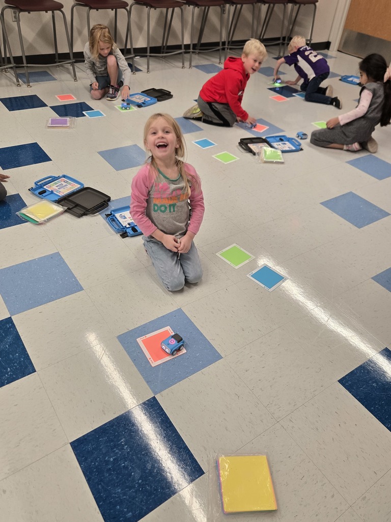kindergarten and first grade students working with indi race car in stem
