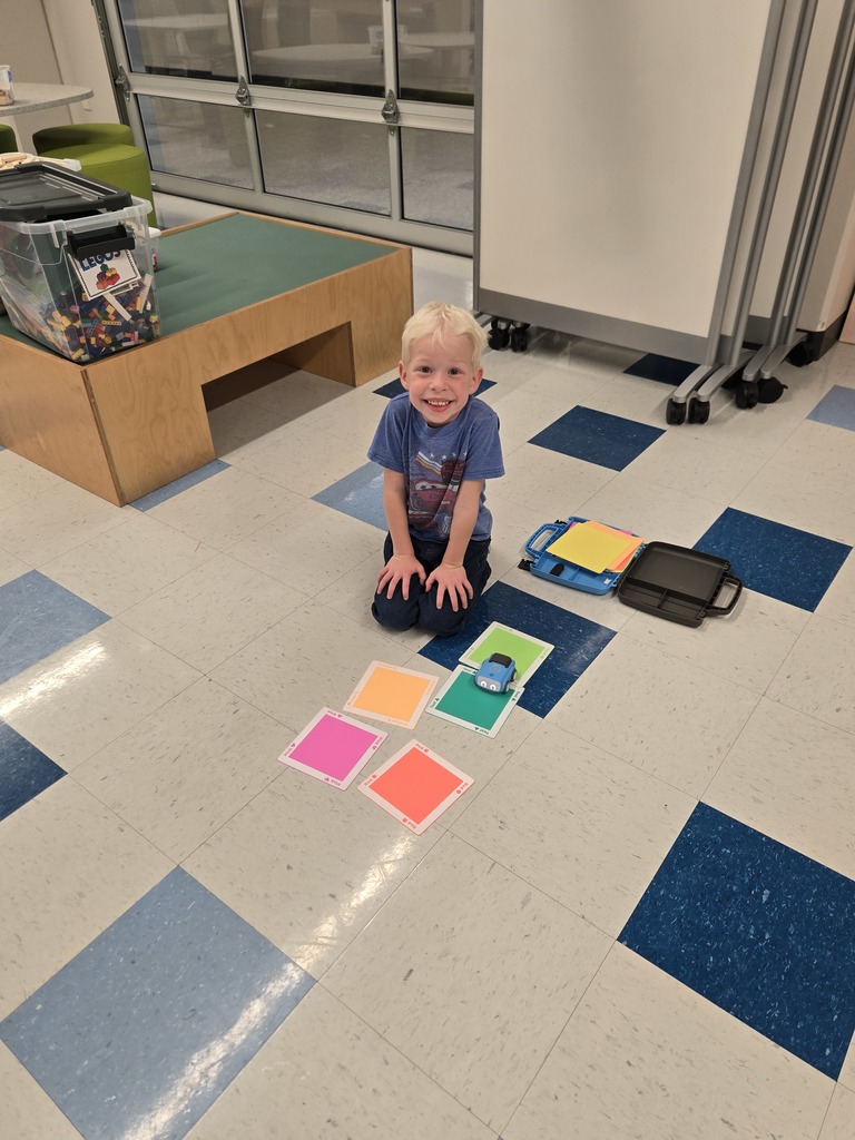 kindergarten and first grade students working with indi race car in stem