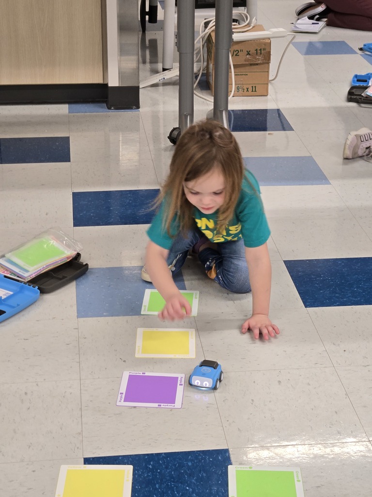 kindergarten and first grade students working with indi race car in stem