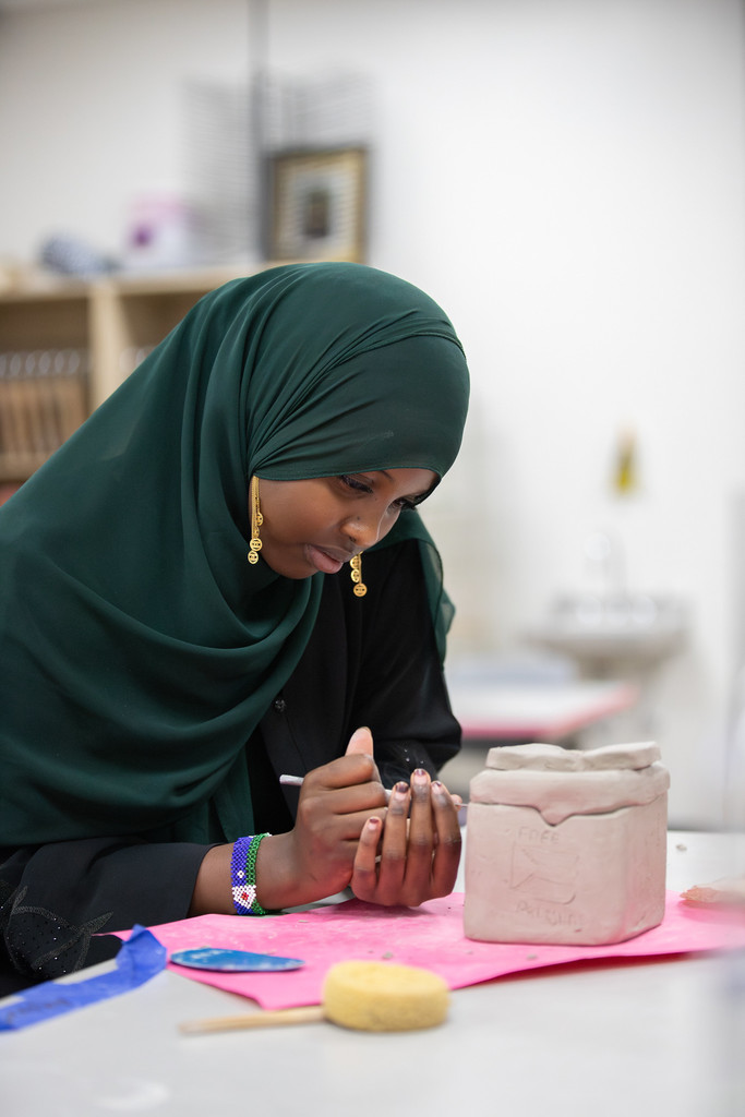 high school studentsworking on pottery