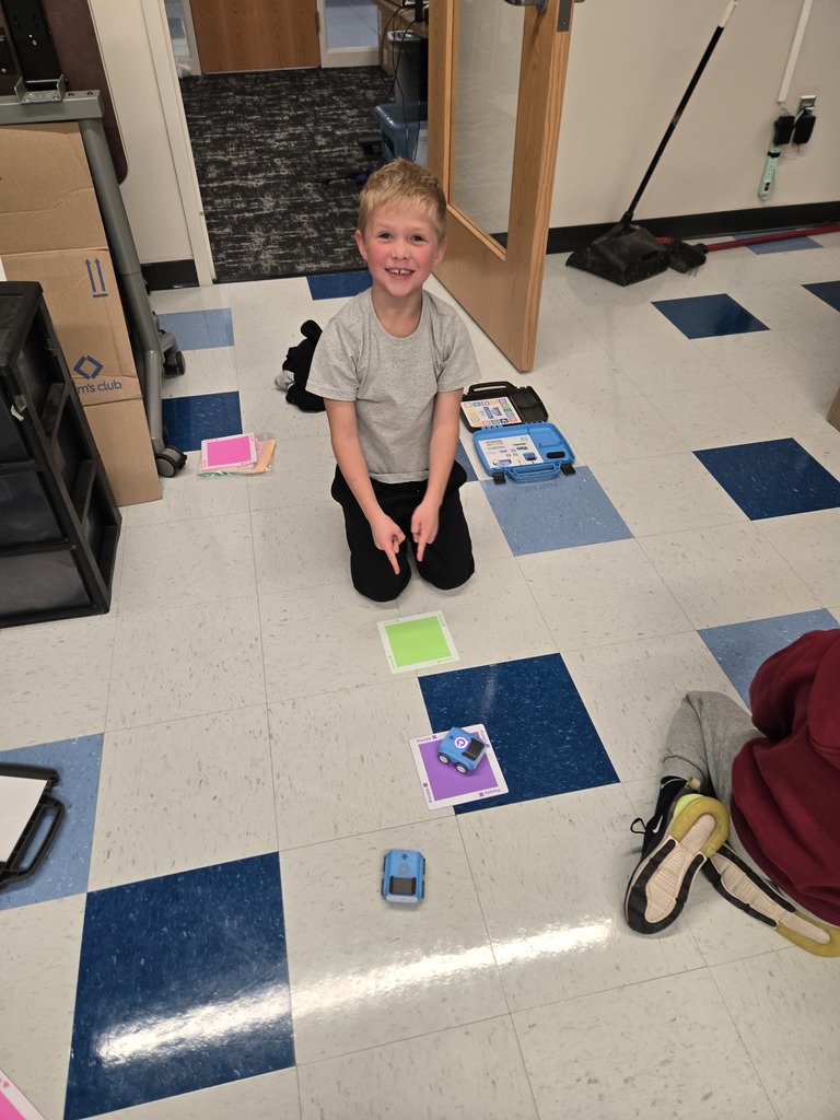kindergarten student working with robot cars in steam class