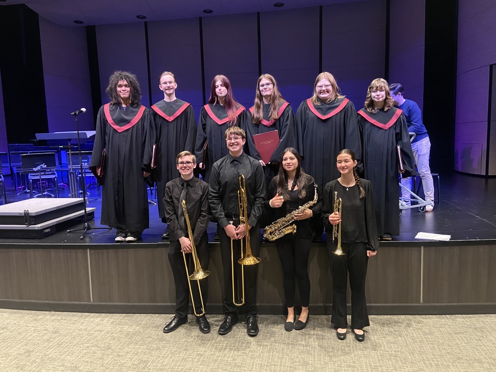choir students and band students posing for photo