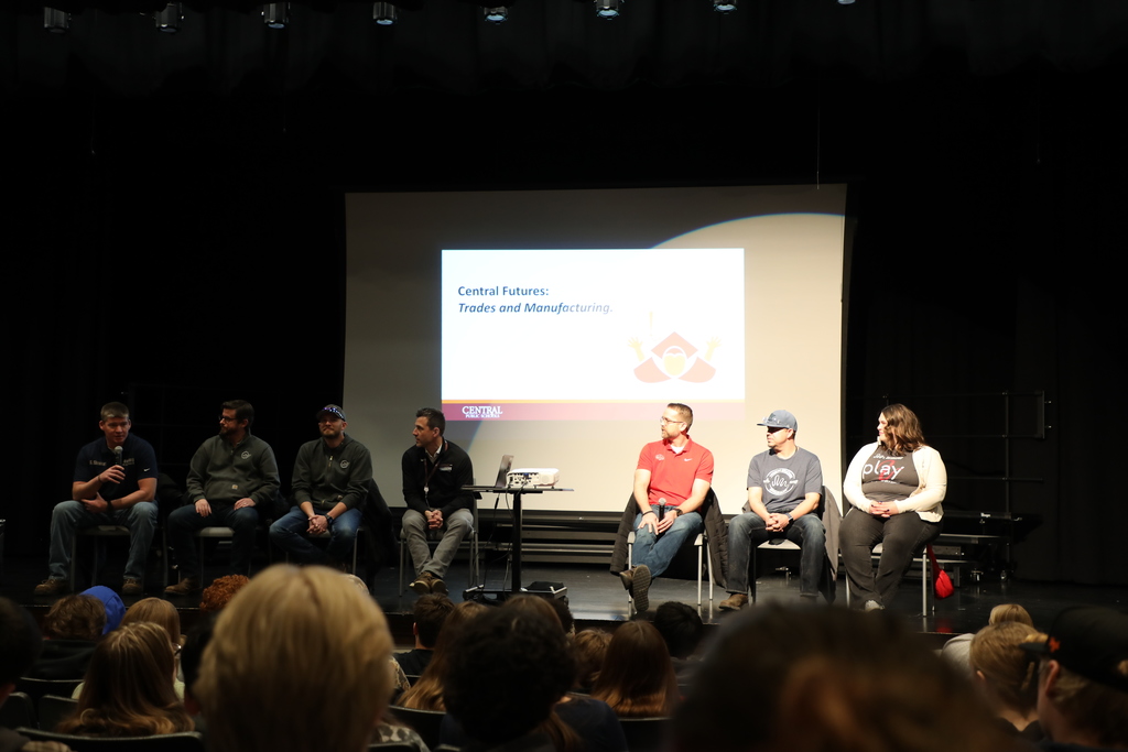 6 people who work in different trades, giving a presentation to high school students