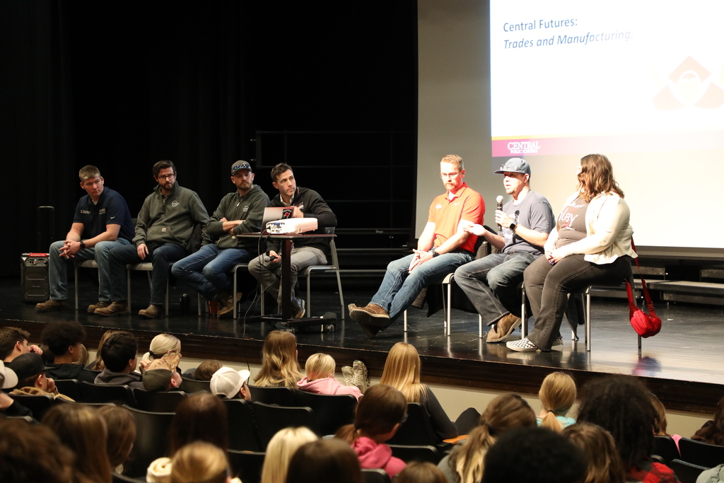 6 people who work in different trades, giving a presentation to high school students