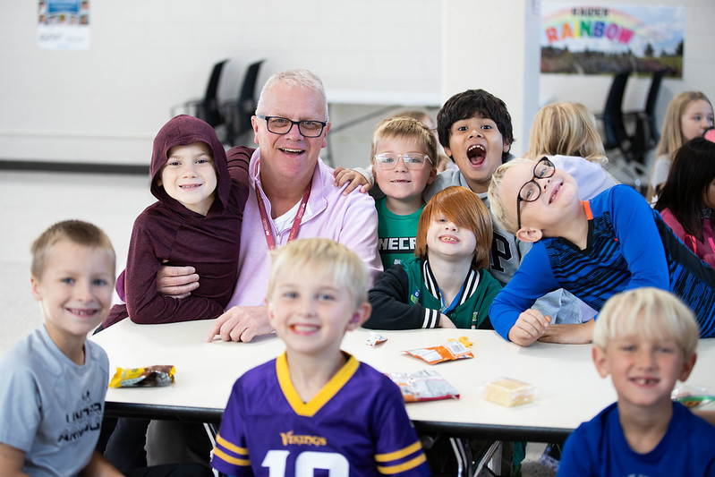 elementary students smiling with principal