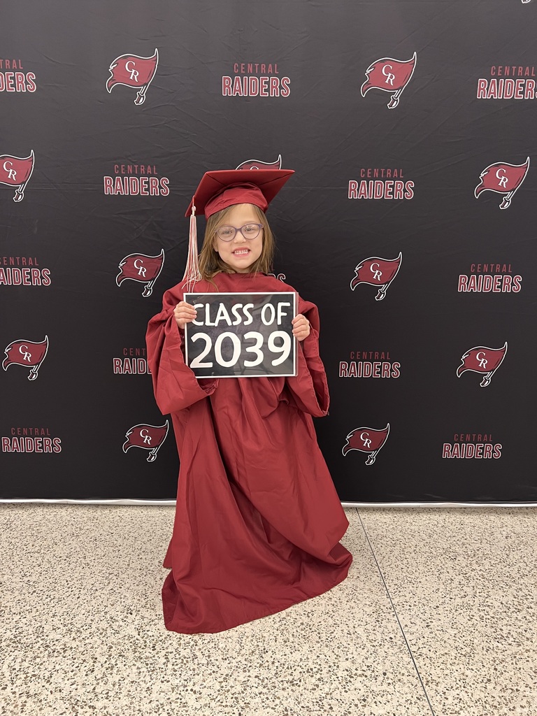 future kindergartener in cap and gown holding sign that says class of 2039