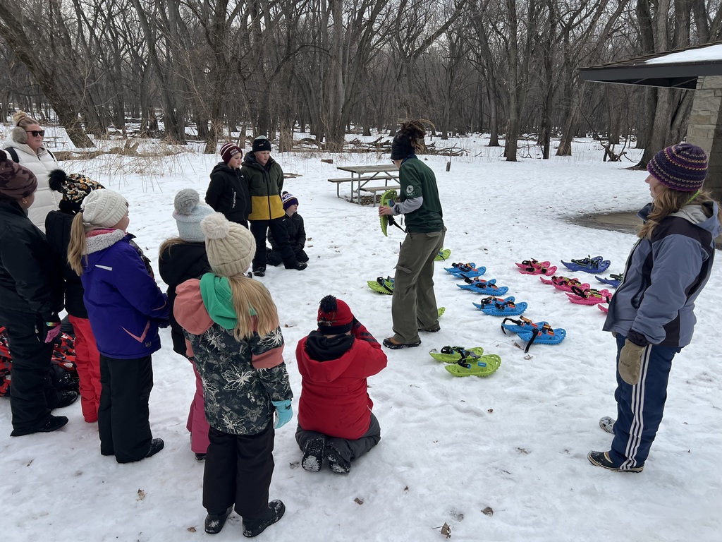 students preparing to snowshoe