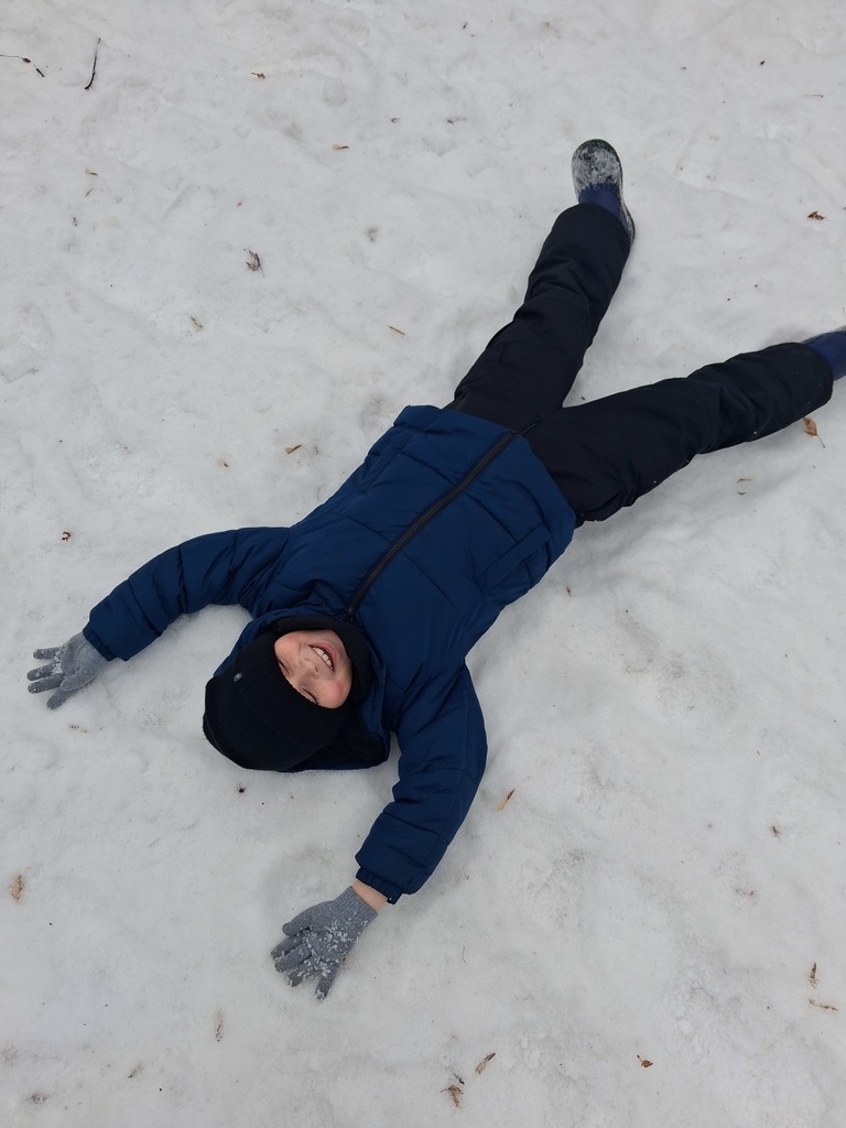 student playing in the snow