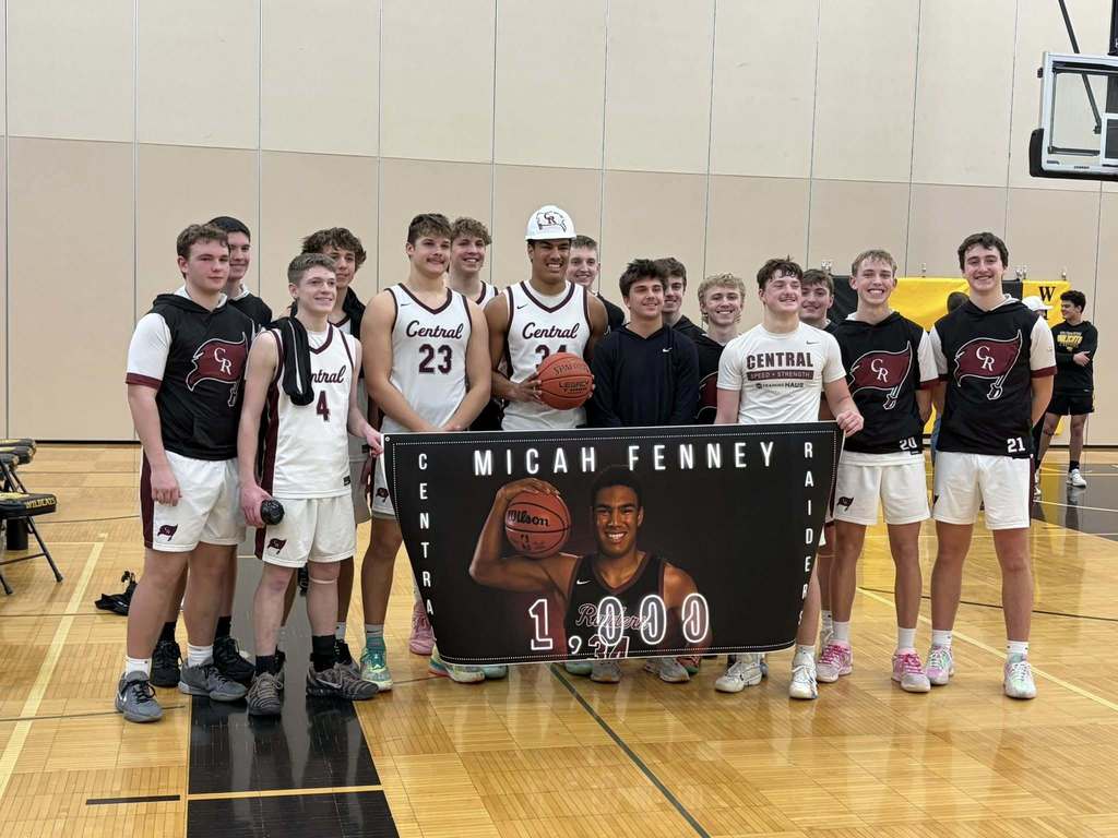 A high school basketball player with his teammates after reaching 1,000 points.