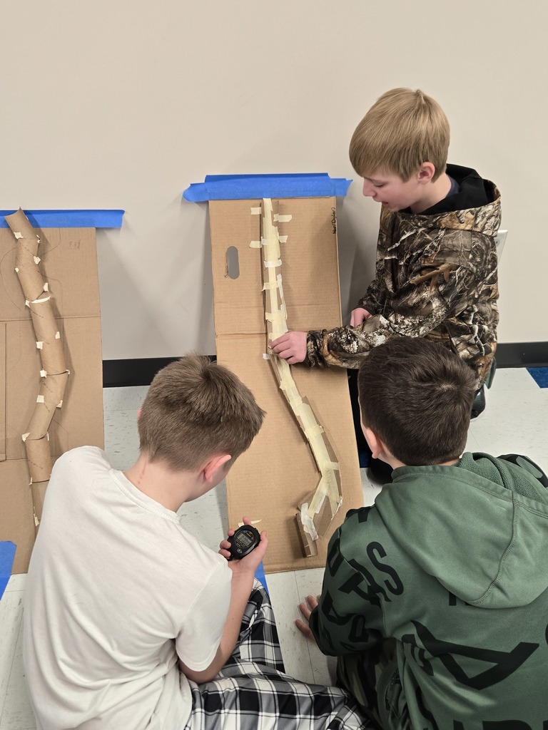 students creating bobsleds with cardboard and gummy bears