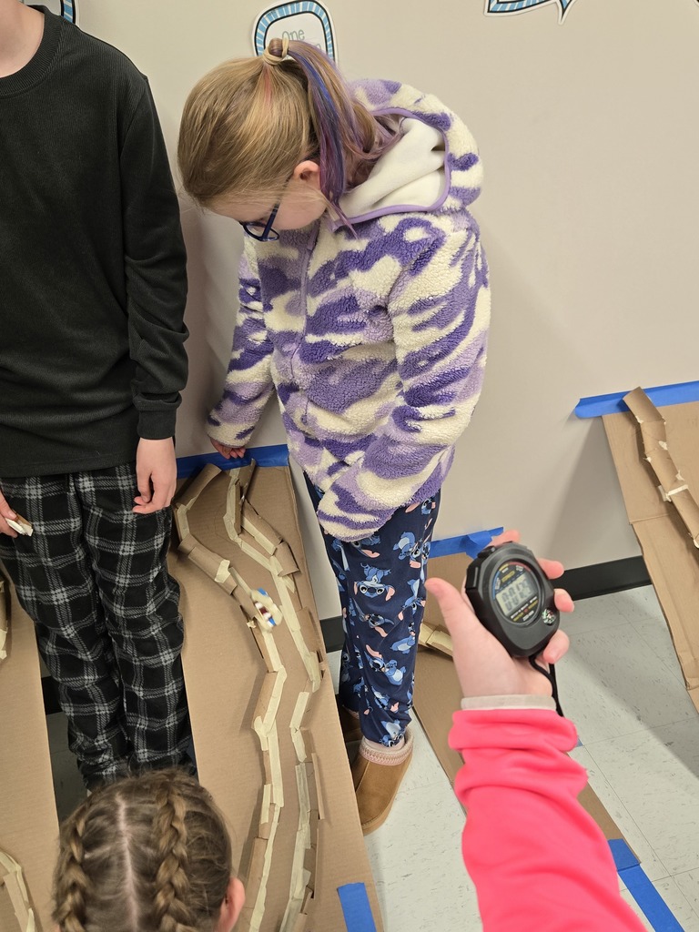 students creating bobsleds with cardboard and gummy bears